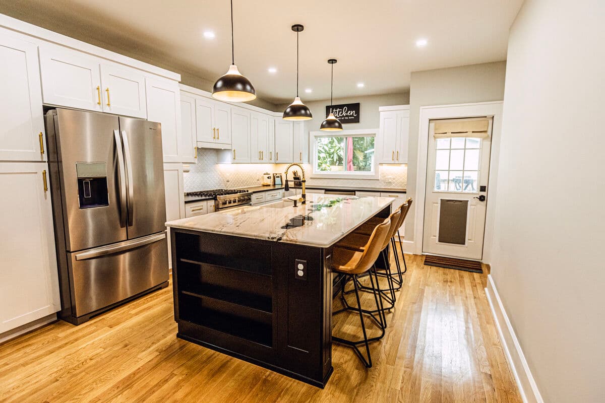Same kitchen after remodel — open concept with modern finishes