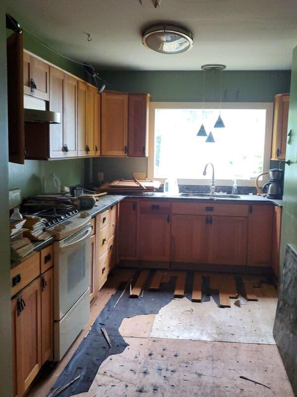 Kitchen before remodel — dated cabinets and closed floor plan