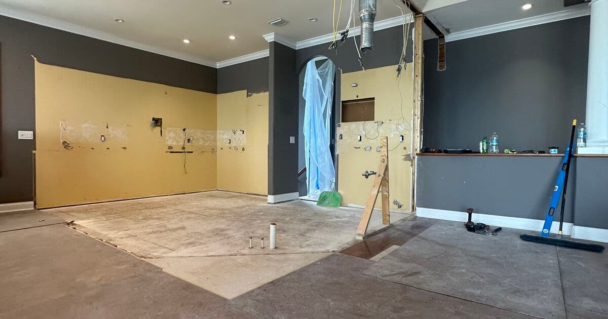 Open-plan kitchen and living area demolition in progress during a St. Petersburg remodel