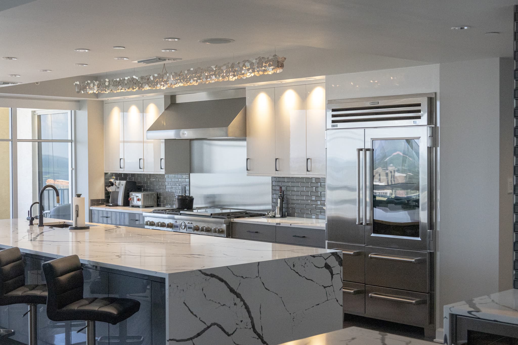 Luxury condo kitchen island with waterfall quartz countertop