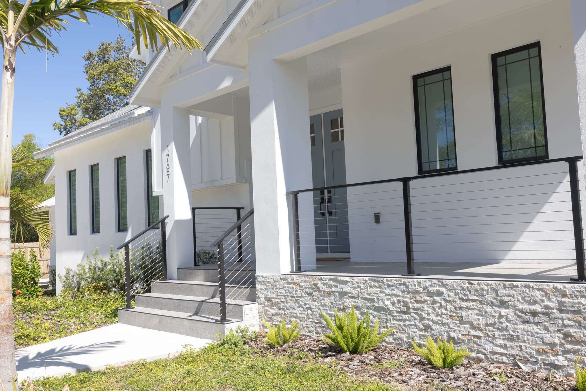 Completed elevated home with covered porch entry in a Pinellas County flood zone