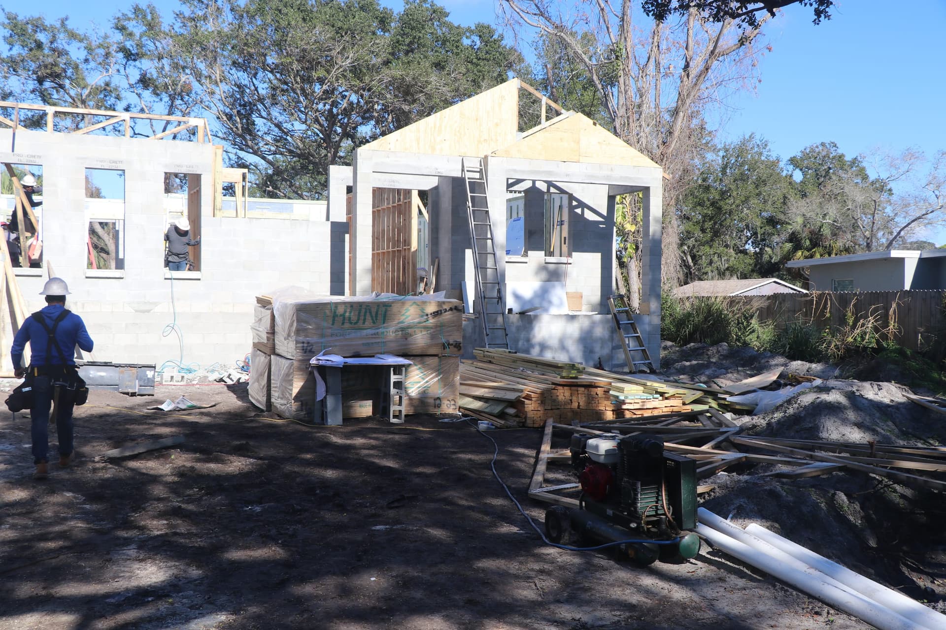 Two-story elevated home framing in progress at a Pinellas County flood zone jobsite