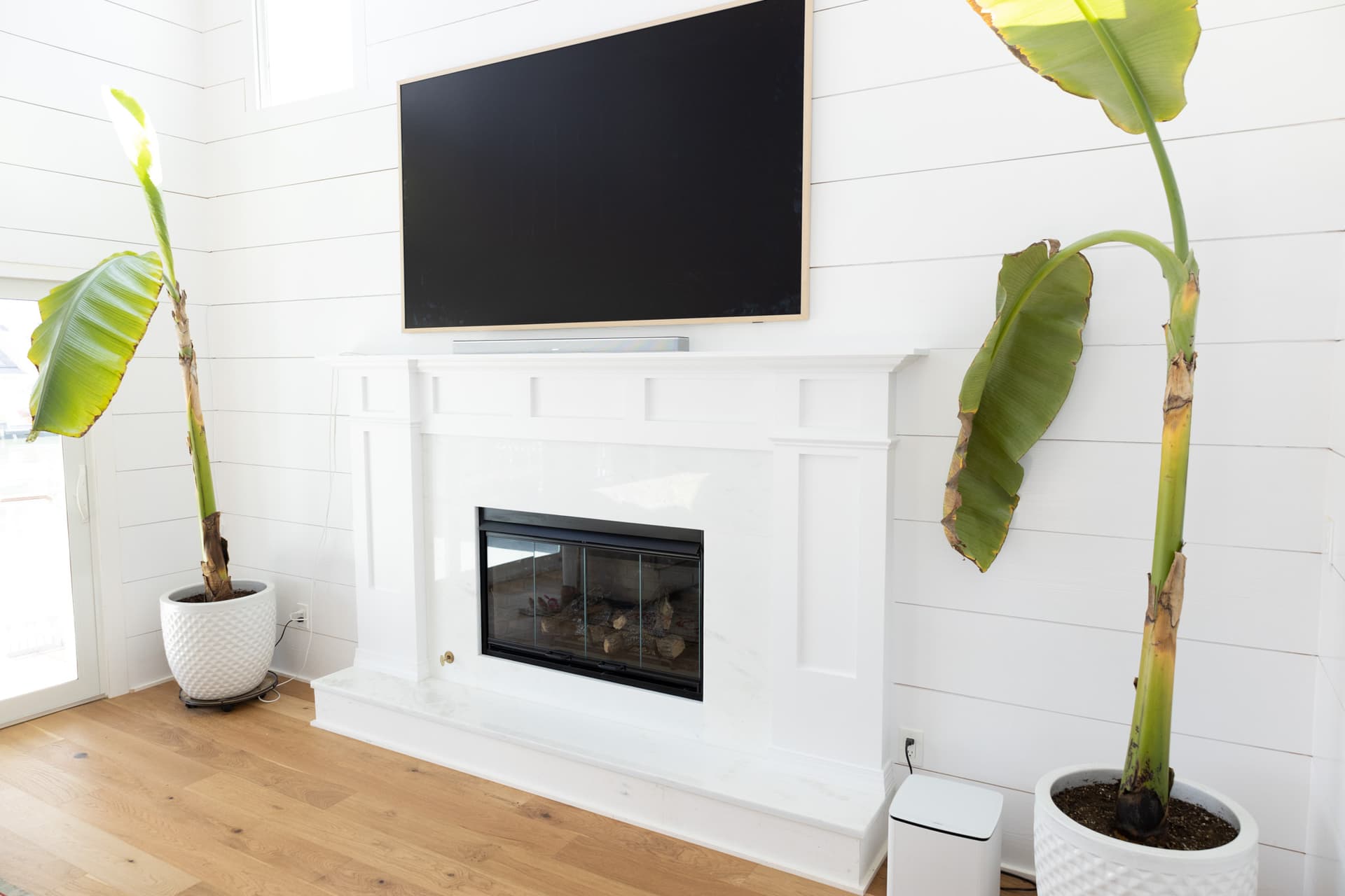 Finished living room with fireplace inside an elevated bayview home