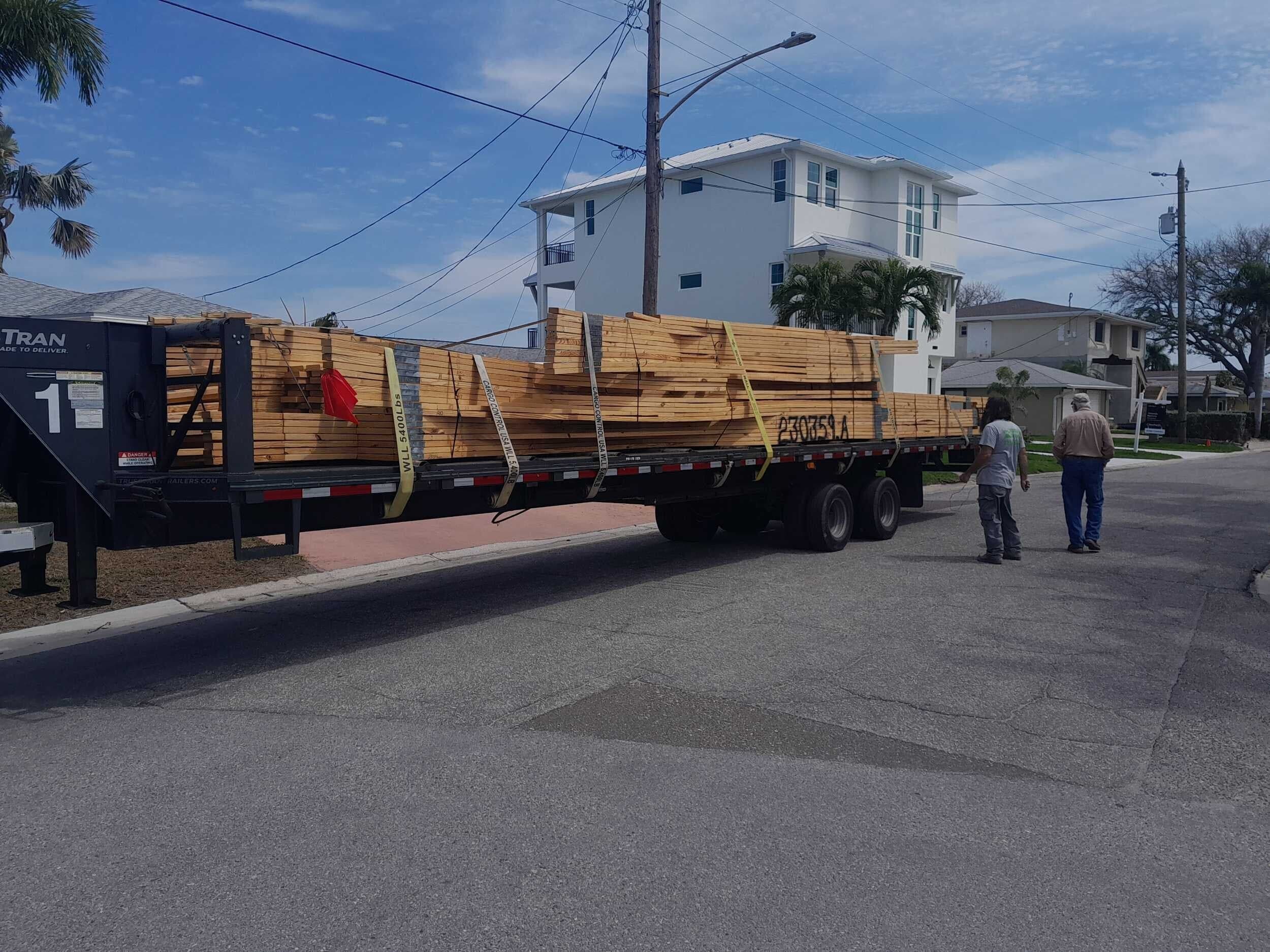 Lumber delivery arriving at a custom home construction site in St. Petersburg
