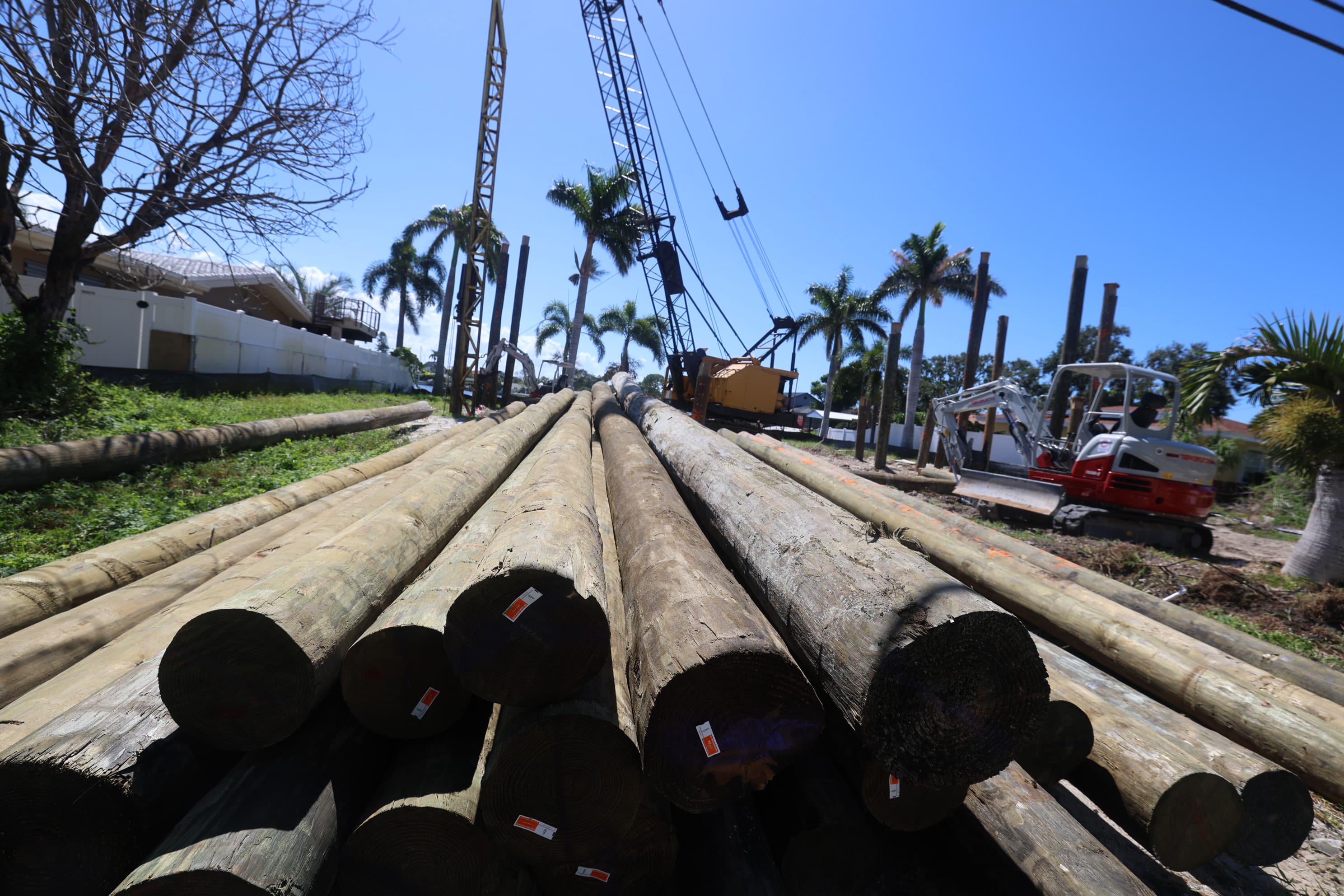 Foundation pilings being installed at a waterfront home building site