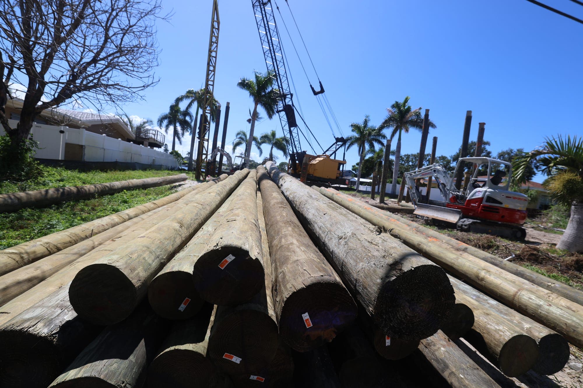 Foundation pilings being installed at a waterfront home building site
