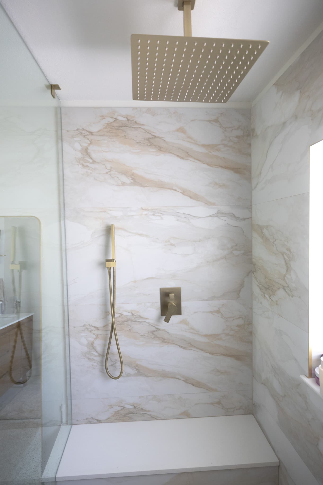 High-end master bathroom shower with frameless glass and marble tile in Snell Isle