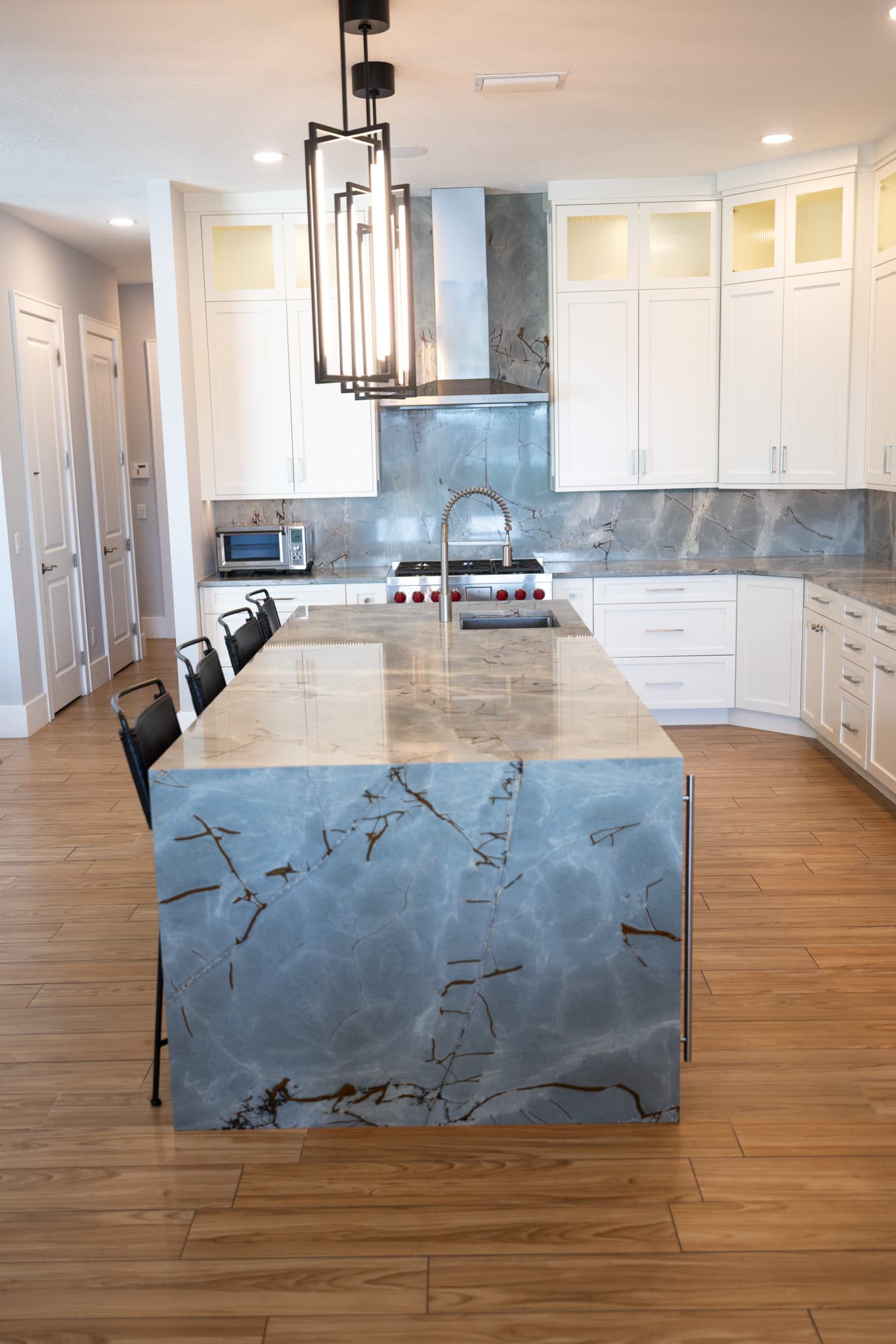 Custom kitchen island with premium countertops and pendant lighting