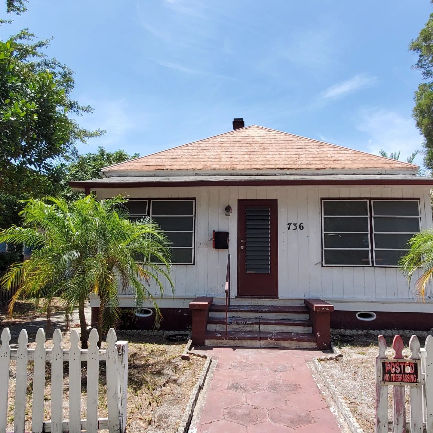 Dated St. Petersburg bungalow exterior showing a home that needs renovation or replacement