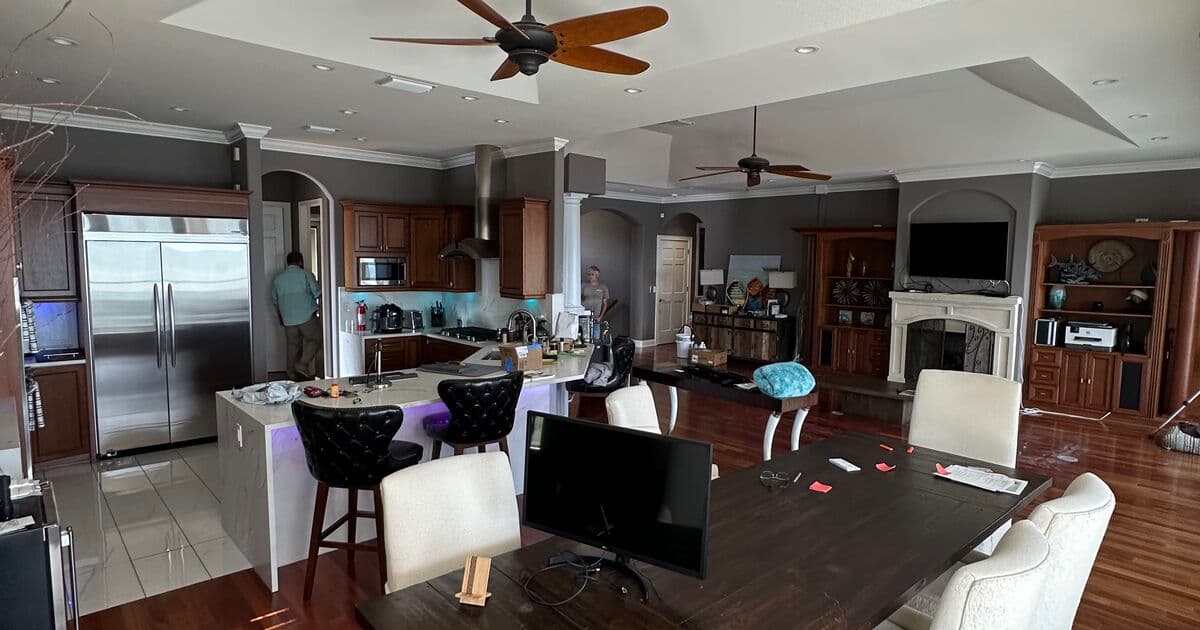 Completed waterfront home interior with open-plan living, tray ceilings, and water views in St. Petersburg