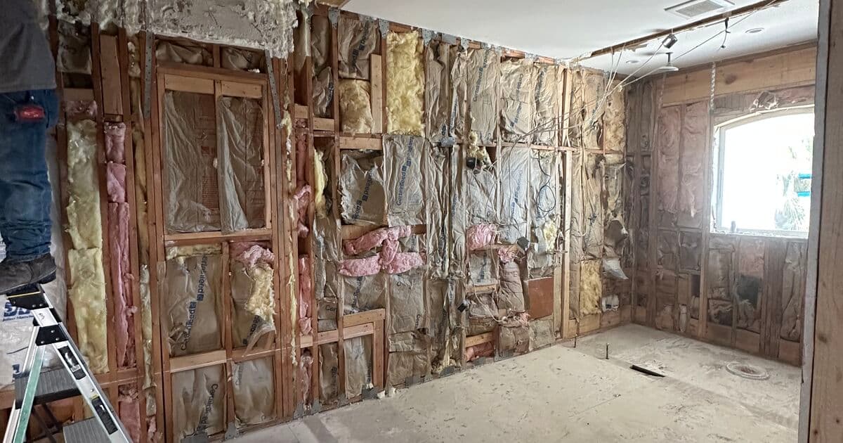 Room stripped to studs during a whole home remodel in St. Petersburg — exposed framing, electrical, and plumbing ready for rebuild