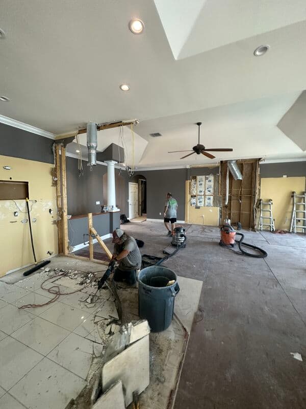Load-bearing wall removal during a whole home remodel — open plan demolition showing structural work in progress