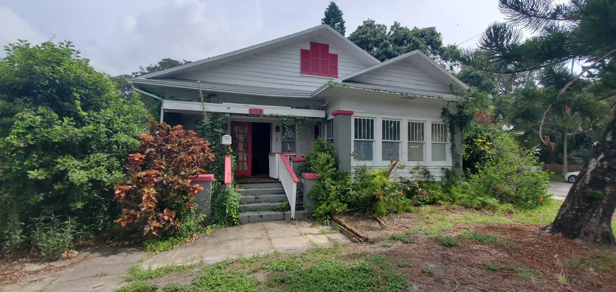Pre-renovation 1920s wood-frame bungalow exterior, original siding — 175 19th Ave SE Old Southeast historic bungalow restoration