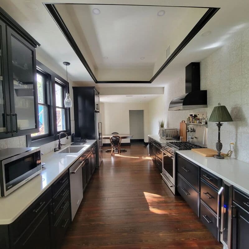 Completed kitchen remodel in a Craftsman bungalow by Revolution Contractors — open concept, modern cabinetry, original hardwood floors