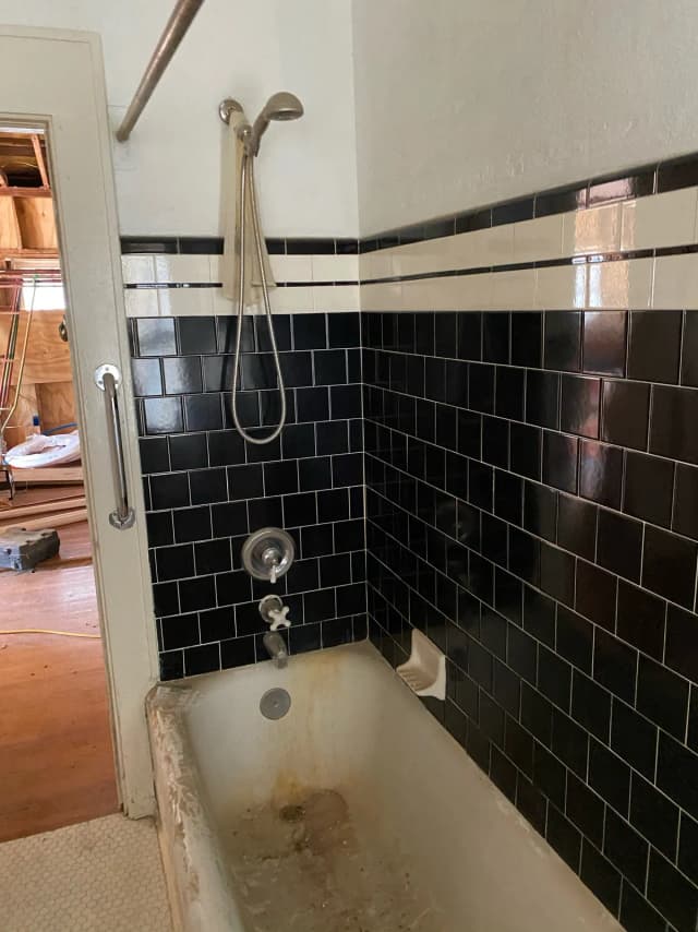 Outdated bathroom with worn tile and dated fixtures in a St. Petersburg home