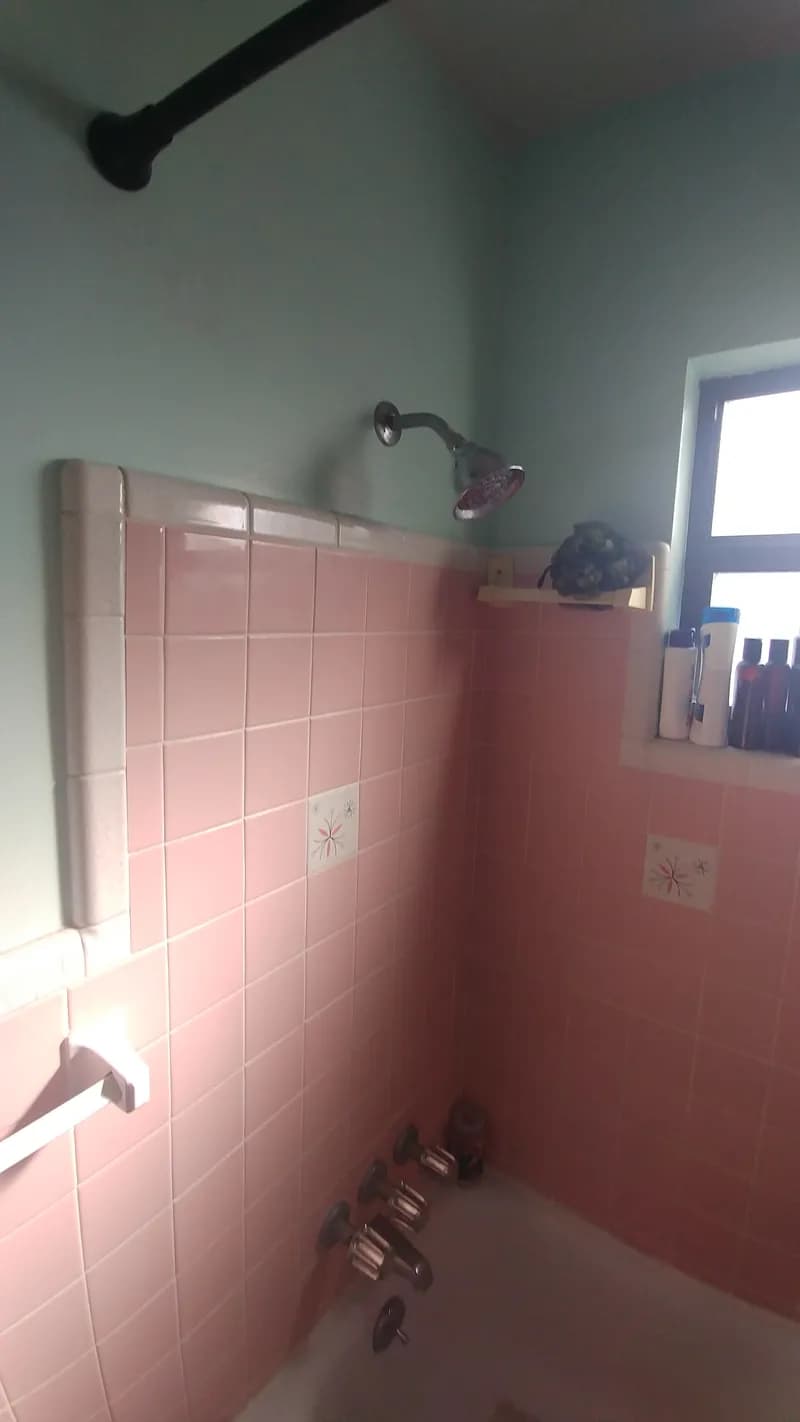 Dated pink tile bathroom before remodel