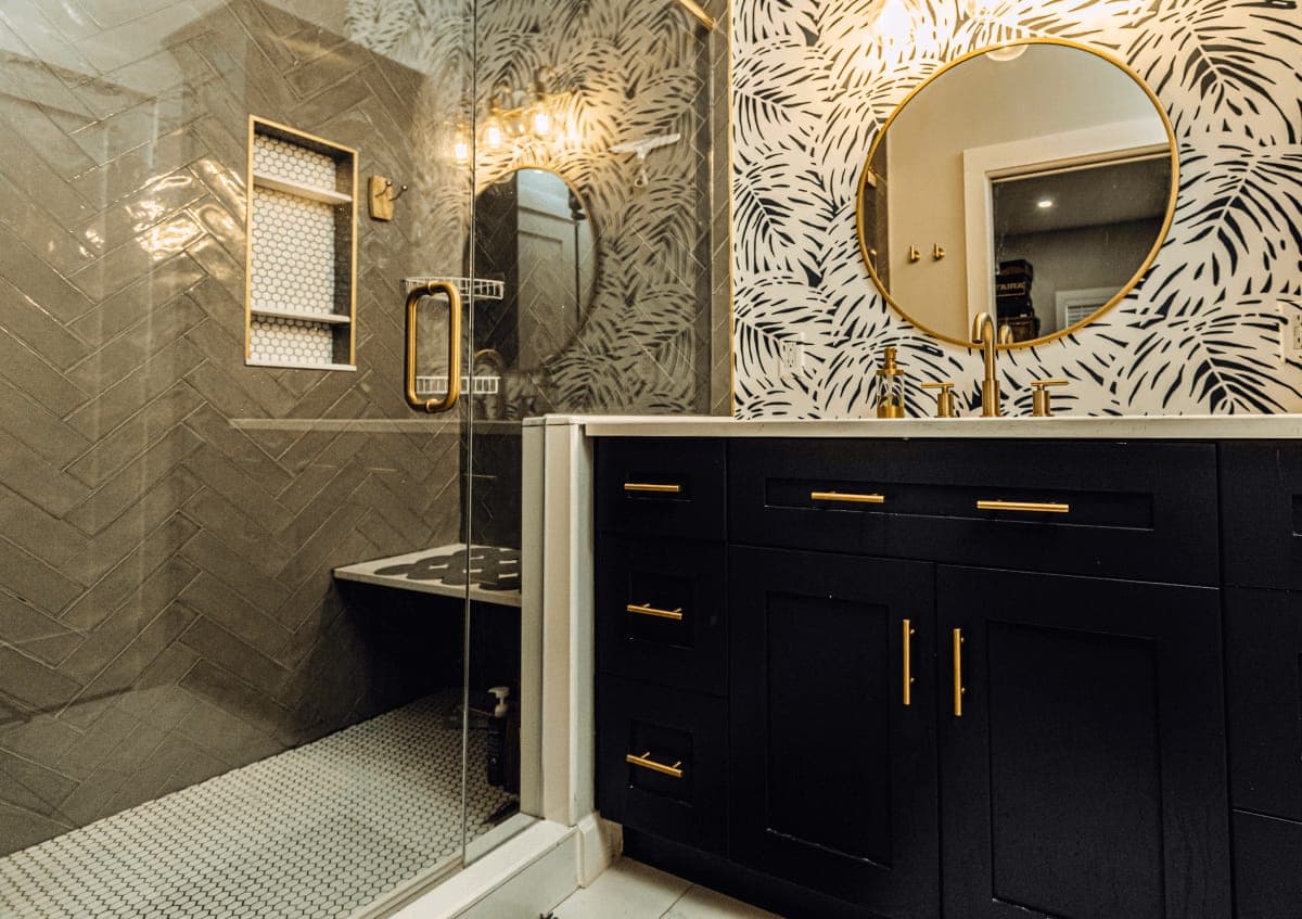 Finished primary bathroom in a St. Petersburg home with quartz double vanity and walk-in shower