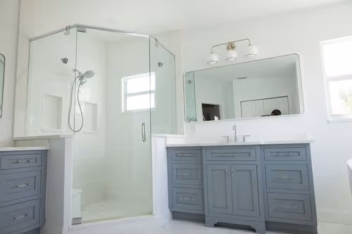 Modern walk-in shower with custom tile work after a full bathroom remodel