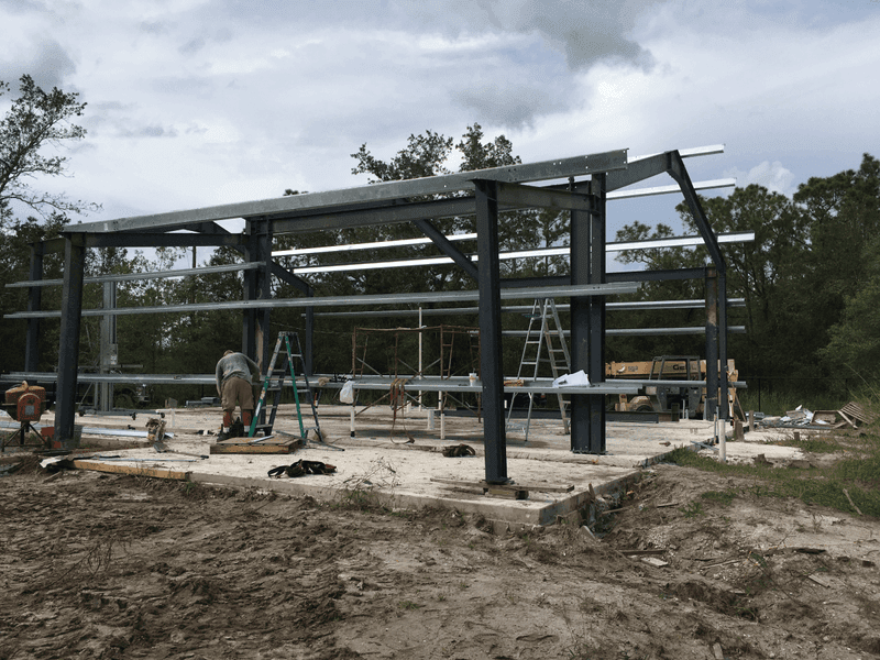 Commercial remodel in St. Petersburg mid-construction with framing, MEP rough-in, and permit stage visible