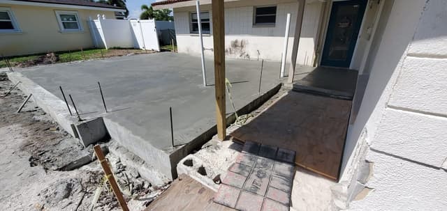 Fresh concrete slab poured for a first-floor home addition in St. Petersburg