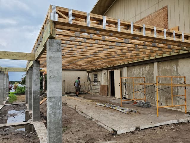 Structural framing and concrete piers for an elevated home addition in Florida