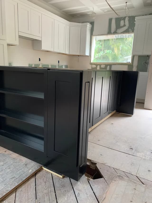 Revolution Contractors W-2 carpenters installing custom kitchen cabinetry