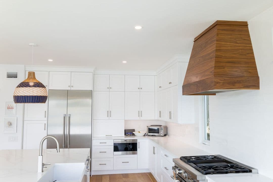 Finished kitchen remodel in a St. Petersburg home showing custom cabinetry, stone counters, and modern appliances
