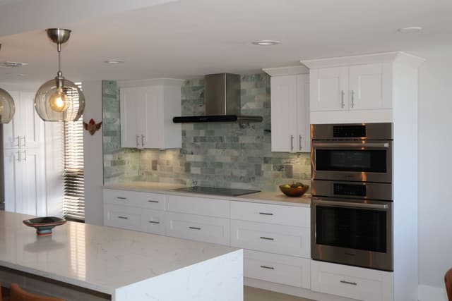Kitchen remodel featuring natural stone countertops and modern cabinetry