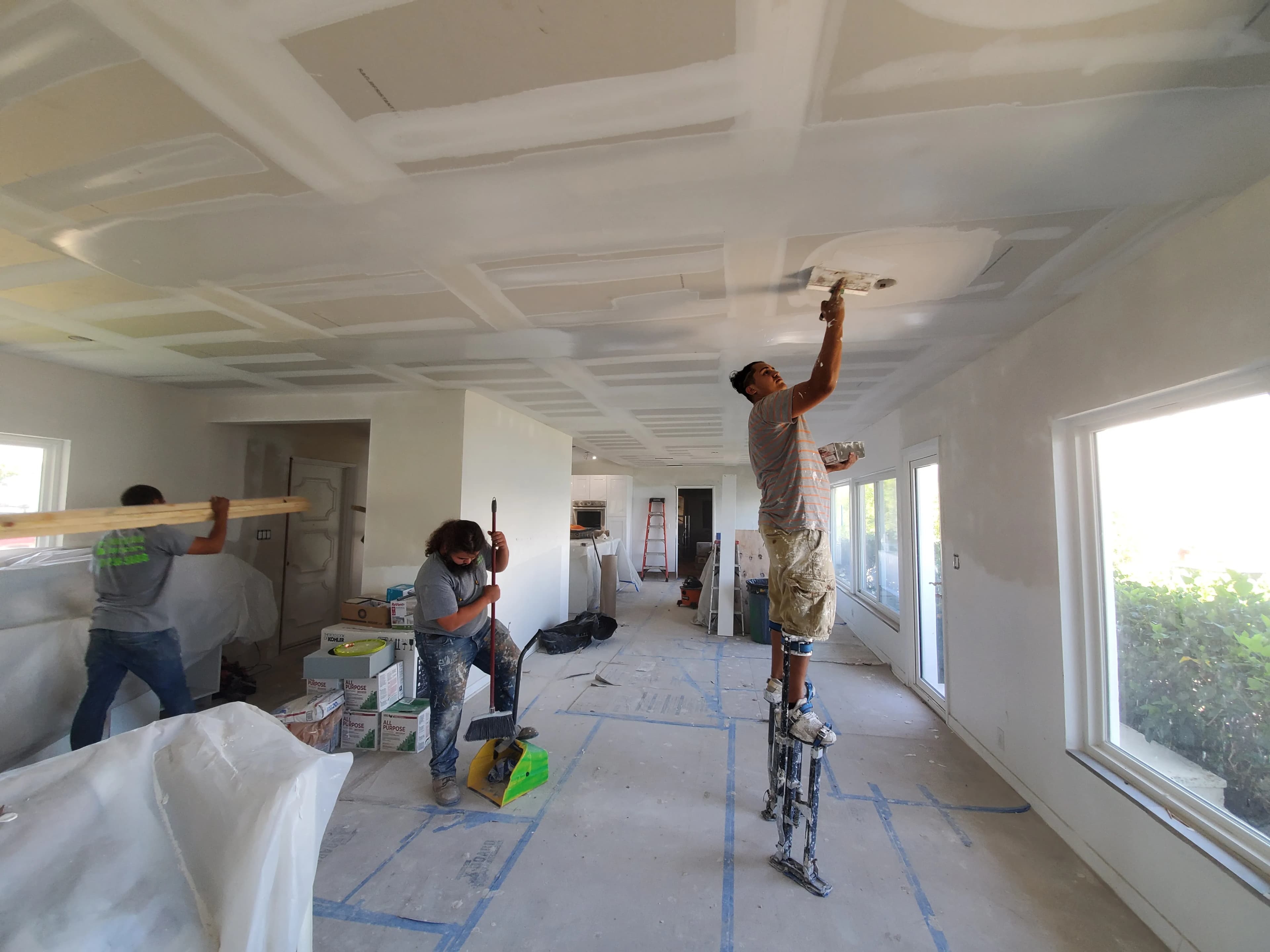 Revolution crew working on kitchen drywall