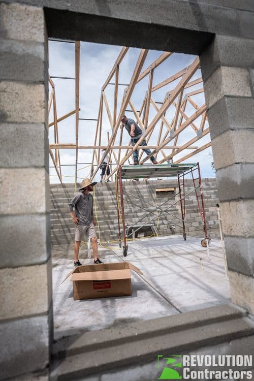 Custom home under construction in St. Petersburg during MEP rough-in phase with framing exposed and mechanical, electrical, and plumbing trades in progress