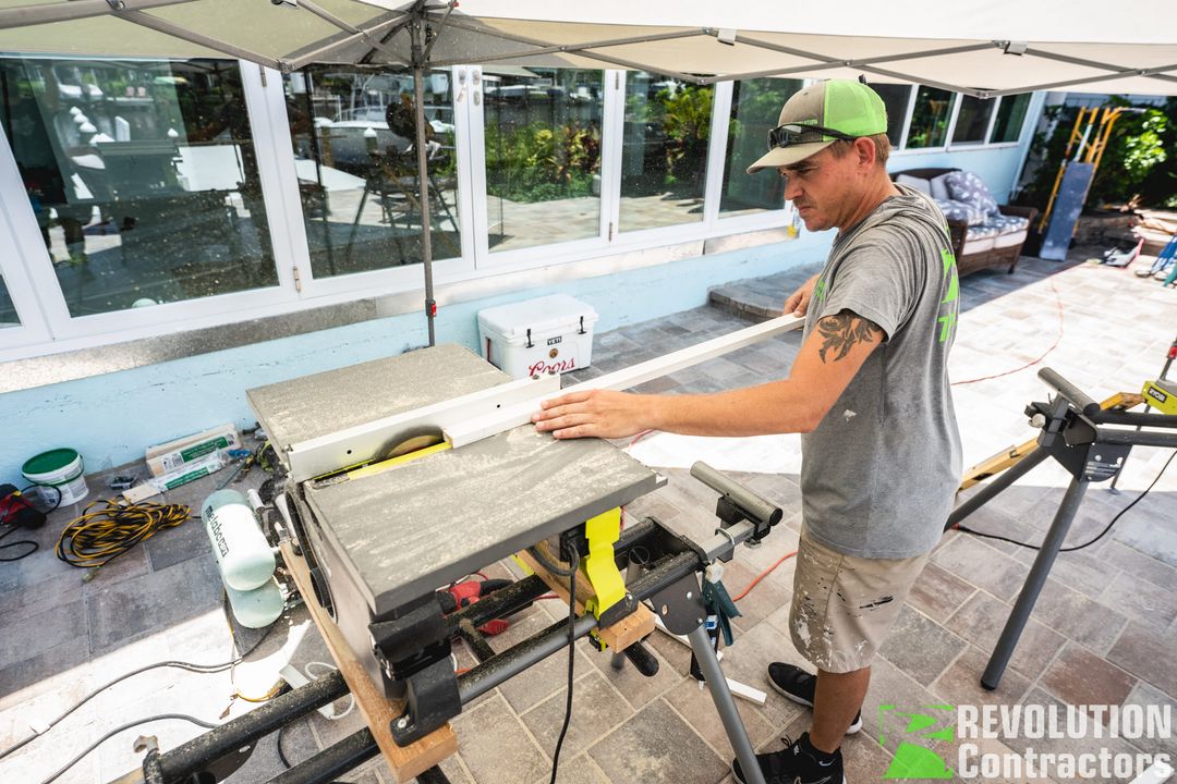 Revolution Contractors crew member cutting trim for a door installation