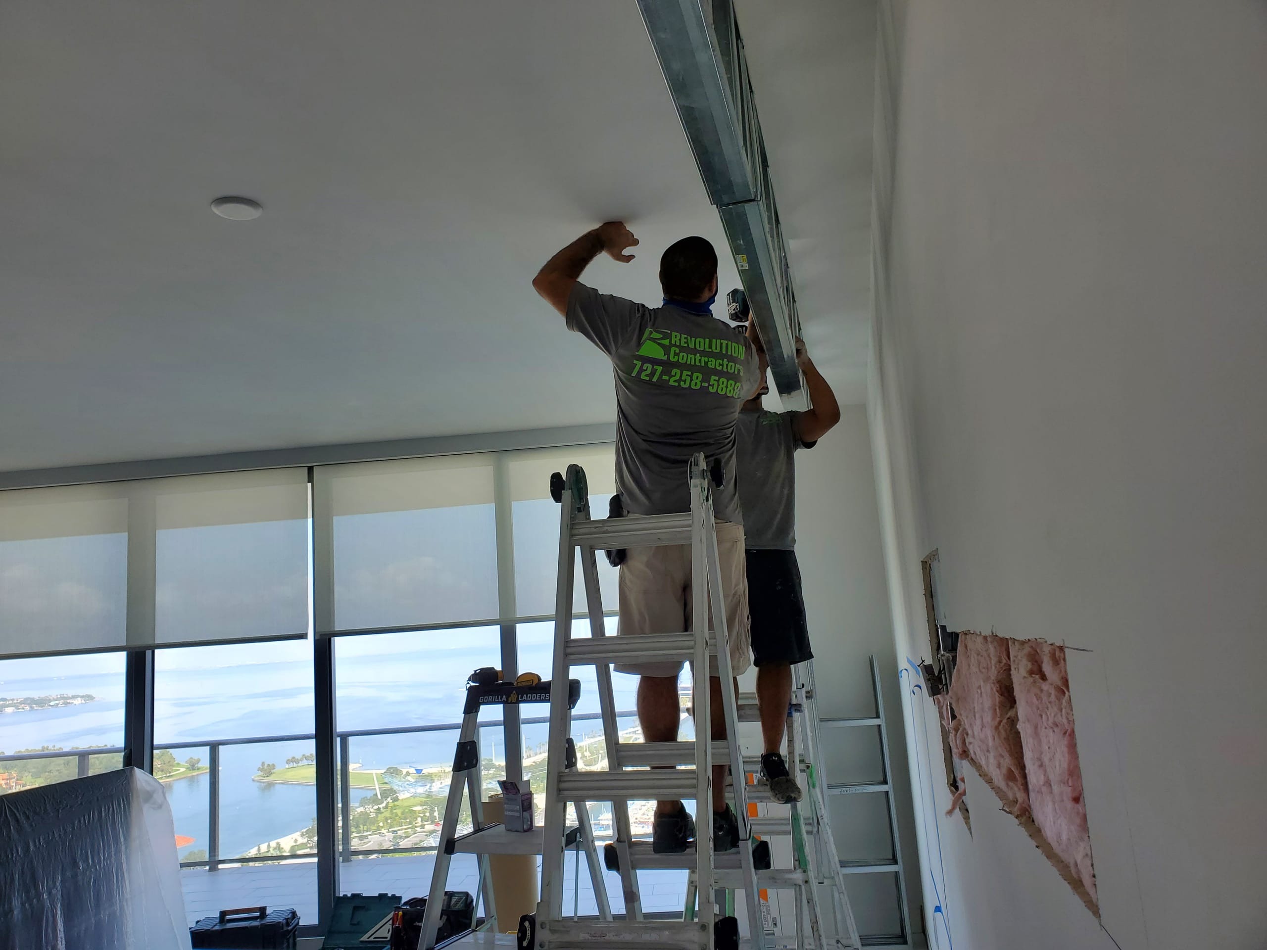 Revolution Contractors crew framing ceiling in downtown St. Pete high-rise condo