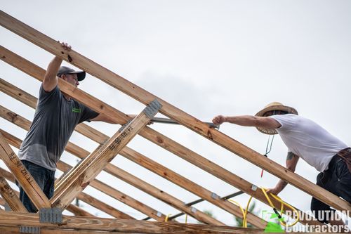 Workers setting roof trusses on a St. Petersburg custom home